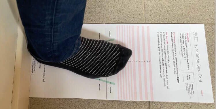 Lay the shoe size chart up against a wall on a hard floor and stand with one foot on it