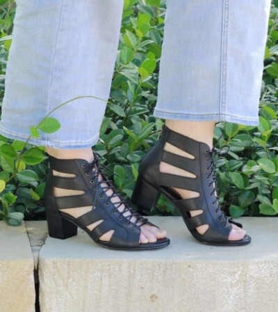 Feet wearing Jacob + Therese black Lacey boots with jeans