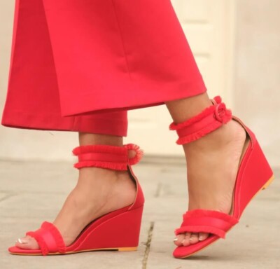 Feet wearing Vaila Angela red wedge heels